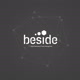 beside