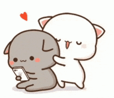 Kawaii gif. Gray cat with floppy ears plays on a smartphone. White cat runs up, flailing its arms, and then hugs the gray cat’s big head.