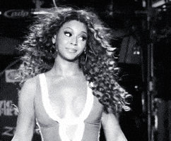 Video gif. A black-and-white clip of Beyonce dancing while ignoring someone offscreen, as if to say "whatever".