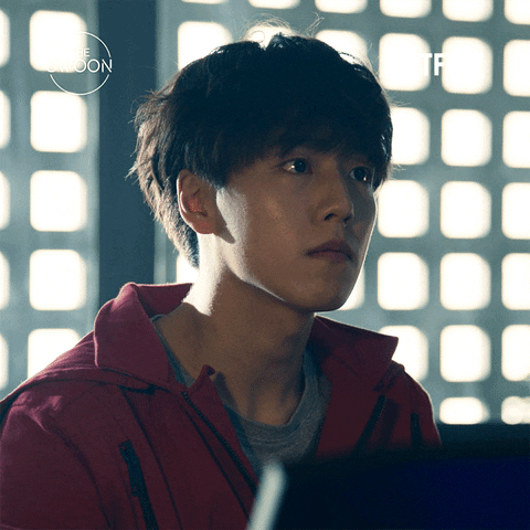 TV gif. Lee Hyun-woo as Rio in Money Heist: Korea. He's listening intently as someone speaks and he looks away as considers what they've said and clears his throat.
