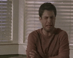 TV gif. James Roday Rodriguez as Shawn in Psych sits with his arms crossed and appears to wail with his eyes squeezed shut.