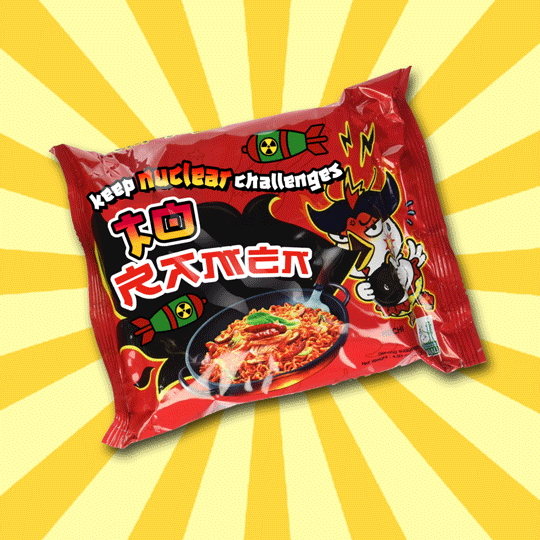 Text gif. Bright red package of dried ramen with an angry chicken, surrounded by missiles and lightning bolts, holding a lit bomb, reads "Keep nuclear challenges" against a spinning yellow background.