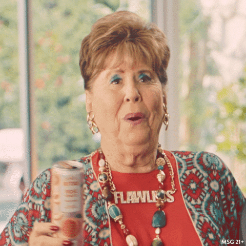 Video gif. A happy old lady holds up a can of Rita’s and dances, enjoying happy hour.