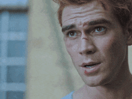 TV gif. KJ Apa as Archie in Riverdale raises his eyebrows with a serious expression on his scuffed-up face while saying "we're gonna get the hell outta here," which appears as text.