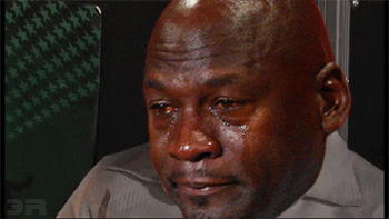 Meme gif. A crying face of Michael Jordan is edited on top of a young man who is wearing a white jumpsuit and he slowly slides down a wall, sitting splayed out and given up.