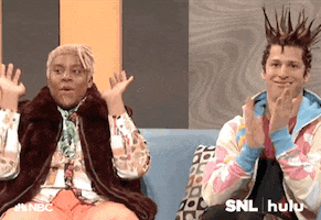 SNL gif. Kenan Thompson as DJ Dynasty Handbag raises the roof while Andy Samberg as T'Shane claps with his nostrils flared in amazement.