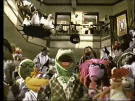 Muppets gif. A crowd of Muppets at eye level and up on a balcony dance in unison as they shimmy and bop their heads.