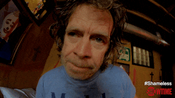 TV gif. William H Macy as Frank in Shameless, vertiginous state magnified by Snorricam, rises up from bed teetering groggily, suddenly jolting into a state of panic and surprise as he falls face first into the floor. 