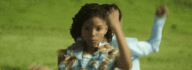 Music video gif. Chloe and Halle stand back to back, singing. They simultaneously bring their fists out in front of them, then flatten their palms and make a "W" sign with their arms. 