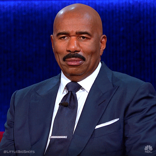 Reality TV gif. Steve Harvey on Little Big Shots smirks and then chuckles with a soft smile. 