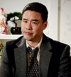 TV gif. Randall Park as Louis Huang on Fresh Off the Boat looks at someone with a disappointed expression and shakes his head slowly.