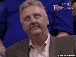 Sports gif. Larry Bird looks up and shakes his head, deeply frustrated.