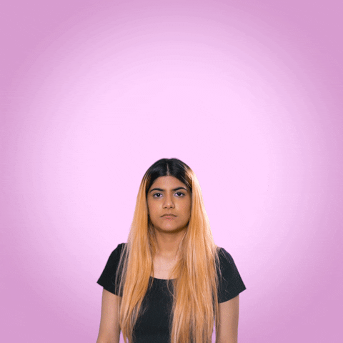 Celebrity gif. Ananya Birla, an Indian singer, shrugs her shoulders and purses her lips while lifting her arms up. In each hand has the text, "IDC," and "IDK."