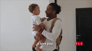 Reality TV gif. Biniyam Shibre carries his son Avi on "90 Day Fiancé" and tells him “I love you.” They then embrace by wiggling and touching each other's noses.