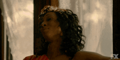 TV gif. Michaela Jaé Rodriguez as Blanca in Pose. She shakes her hair back before looking at us sassily, pursuing her lips as she cocks her head down.