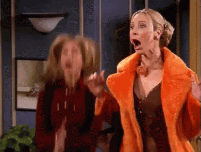 Friends gif. Jennifer Aniston as Rachel and Lisa Kudrow as Phoebe jump up and down, clapping their hands and screaming with excitement.