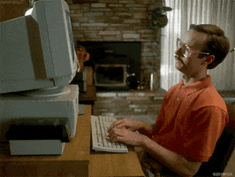 Movie gif. Aaron Ruell as Kip in Napoleon Dynamite slouches as he sits back and types on a keyboard as if working. 