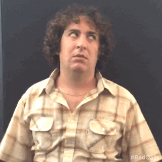 TV gif. Oliver Cooper as Wheeler from Red Oaks. He does one big shrug of his shoulders as he sighs and looks to the side, annoyed. 