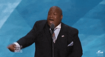 Political gif. Mark Burns is speaking at a podium and he raises his hand in the air while giving a rallying fist pump.