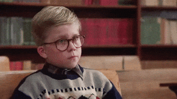 Movie gif. Peter Billingsley as Ralphie from A Christmas Story puts his head down on top of his arms at his school desk, dejected. 