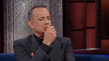 Celebrity gif. Tom Hanks on the Late Show cradles his chin in his hand as if contemplating something.