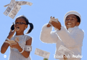 TV gif. Marsai Martin as Diane and Miles Brown as Jack in Blackish each hold a stack of money and flick it out, one bill at a time making it rain money. 