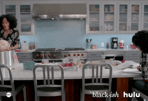 TV gif. Tracee Ellis Ross as Rainbow in Blackish turns to the side as she picks up a mound of dough that slips from her hands as she falls forward in a kitchen.