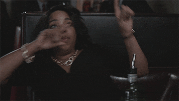 TV gif. Kimberly Hebert Gregory as Belinda Brown on Vice Principals sitting in a booth, tipsy and dancing in her seat.