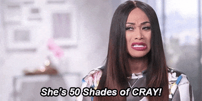 Reality TV gif. Tami Roman from Basketball Wives gives a side-eye and says, "She's fifty shades of cray!"
