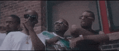 Music video gif. Scene from M-City J.R.'s music video where men are all leaning back exaggeratedly in awe of someone or something passing by.