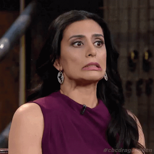 TV gif. Manjit Minhas, a judge from The Dragon's Den, pulls a face and looks horrified at what she's seeing. Her eyes go wide and she grits her teeth while her lips turn down.