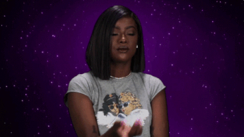 Celebrity gif. Justine Skye has a finger on her chin and she looks around while tapping her finger, contemplating and considering.