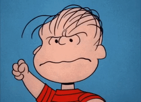 Peanuts gif. Linus furrows his brow and clenches his fists in anger showing clenched teeth.