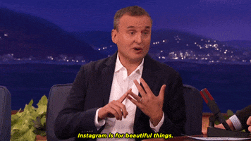 TV gif. Phil Rosenthal on Conan O' Brien holds his hand up and points to one finger while looking at Conan and saying, "Instagram is for beautiful things."