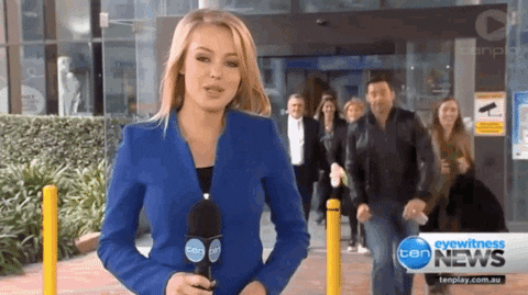 Female news reporter doing a live shot when a man interrupts her. 