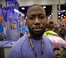 Celebrity gif. Lamorne Morris at San Diego Comic Con. He stares at us and blinks rapidly, feigning shock.