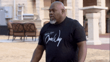 TV gif. David Mann as Leroy in Meet the Browns backs away then runs from a man chasing him. He glances over his shoulder before hooking a left and darting away. 