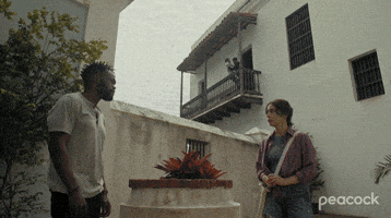 TV gif. Scene from The Resort. Two people fly through a door and off of a balcony as they fight and we see it from the ground floor. Everyone is shocked and runs towards the two men.