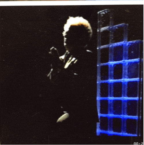 Video gif. Actor John C. Reilly as Dr. Steve Brule sits on a stool illuminated by a spotlight, his eyes closed and his hands clasped together in prayer.