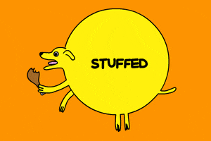 Cartoon gif. Round yellow dog chewing a turkey leg looks full enough to burst against an orange background. Text, “Stuffed.”