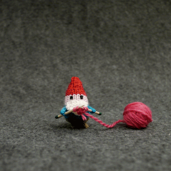 Small knitting gnome makes hearts
