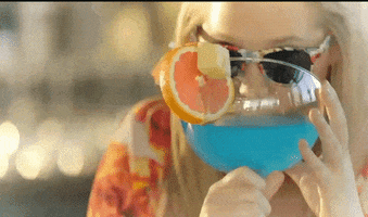 TV gif. Amy Schumer from Inside Amy Schumer. She's holding a giant blue cocktail and lifts it up to take a sip.