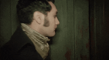 Movie gif. Taika Waititi as Viago in What We Do In The Shadows. He's about to enter a doorway but thinks better of it and turns back to give us an awkward smile.