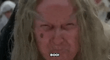 Movie gif. Margery Mason as the Ancient Booer in The Princess Bride signals disapproval by screaming "boo!"
