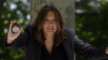 TV gif. Mariska Hargitay as Olivia on Law & Order: Special Victims Unit. She puts both hands out to stop someone and she drops her badge, showing that there's nothing in her hands.