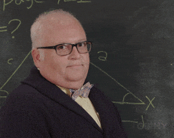 Video gif. A white-haired professor gives the "OKAY" hand sign in front of an old-school green chalkboard. 