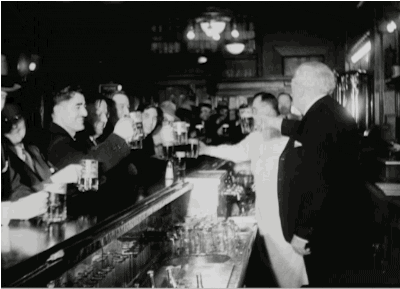 Animated gif of patrons cheering and toasting each other in a bar.