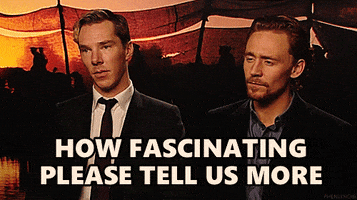Celebrity gif. Looking rather bored, Benedict Cumberbatch chews gum while Tom Hiddleston slowly nods. Sarcastic text, "How fascinating, please tell us more."