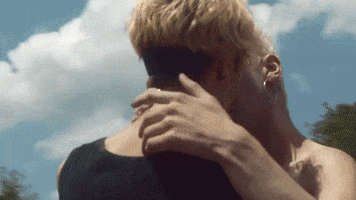 Music video gif. We spin around two queer lovers as they passionately kiss in Mainland’s “I Found God” video snippet.