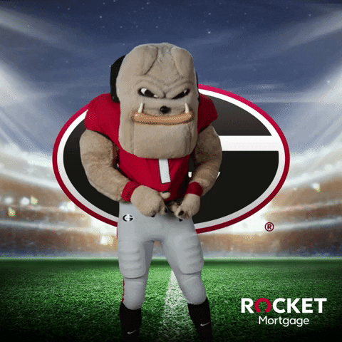 Ad gif. Georgia Bulldogs mascot taps his jersey and taunts us, waving his hands as if to say "bring it on," in front of the team's logo and a football field background. Logo text in the corner, Rocket Mortgage.